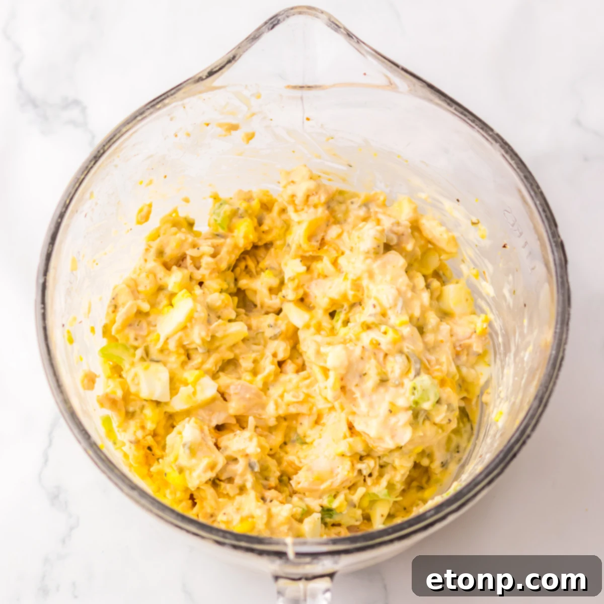 All of the ingredients mixed together in a large glass bowl. 