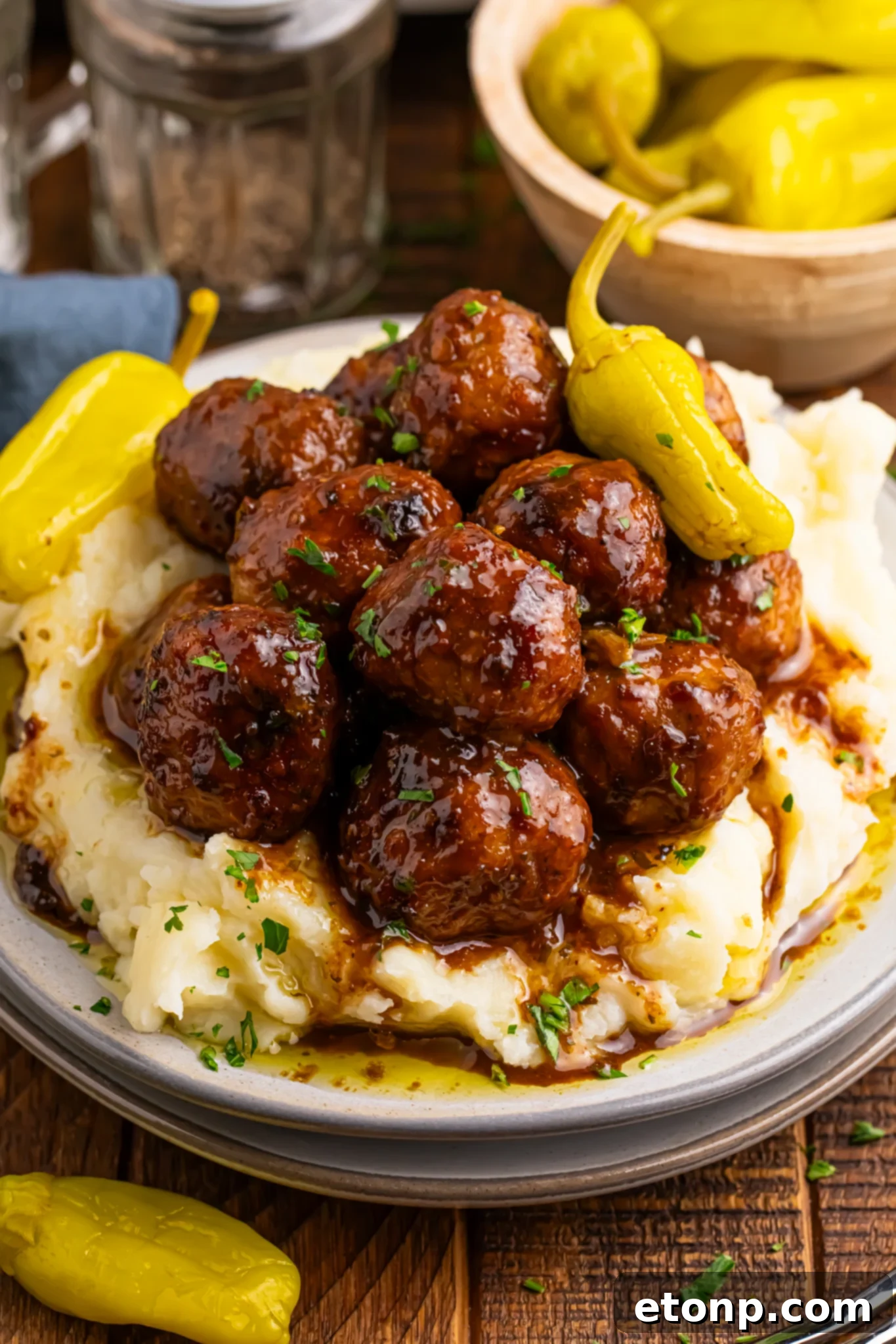 5 Ingredient Crockpot Mississippi Meatballs 2 Crockpot Mississippi Meatballs on a plate with a bed of mashed potatoes underneath