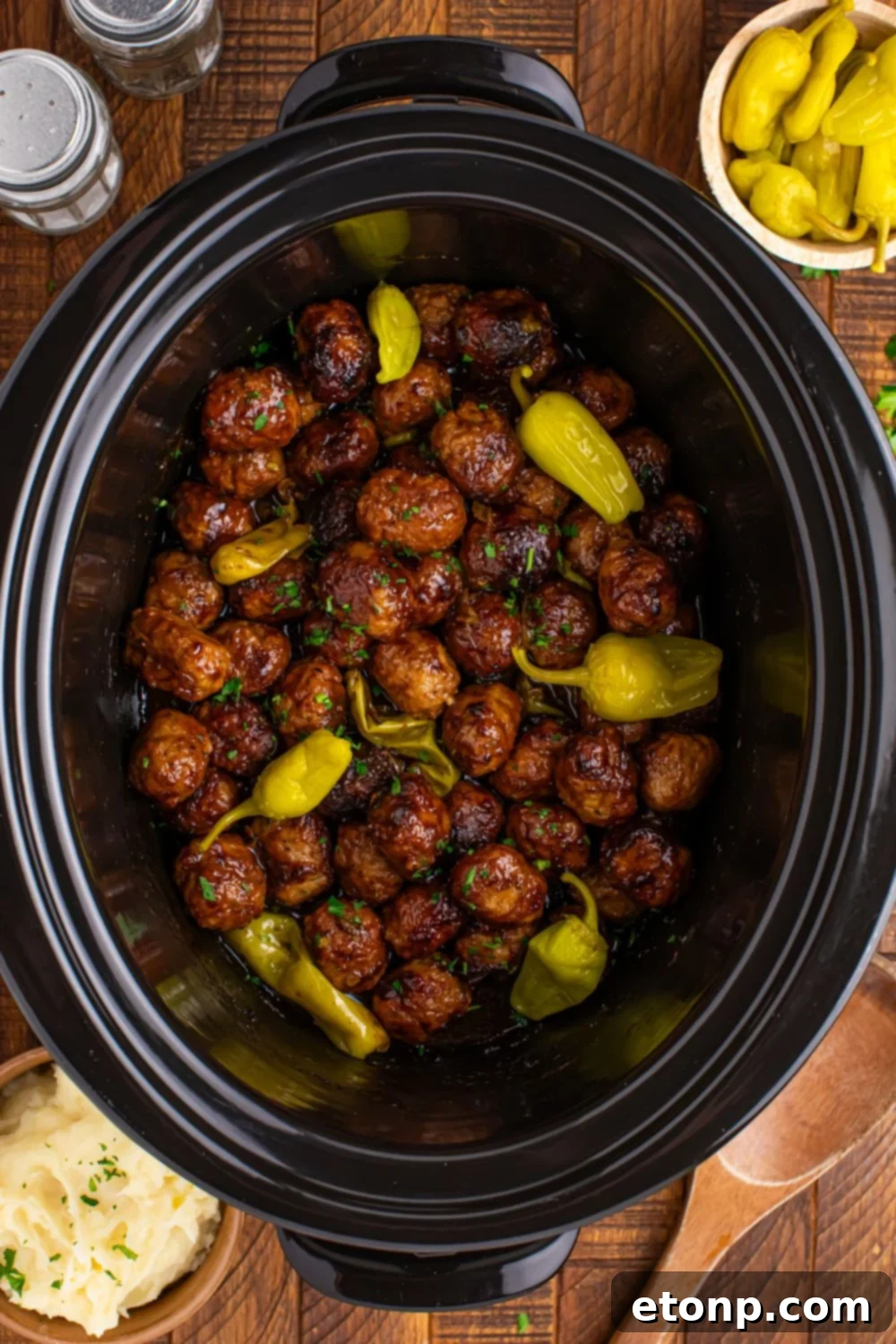 5 Ingredient Crockpot Mississippi Meatballs 12 overhead look of Crockpot Mississippi Meatballs with peppers on top of the meatballs