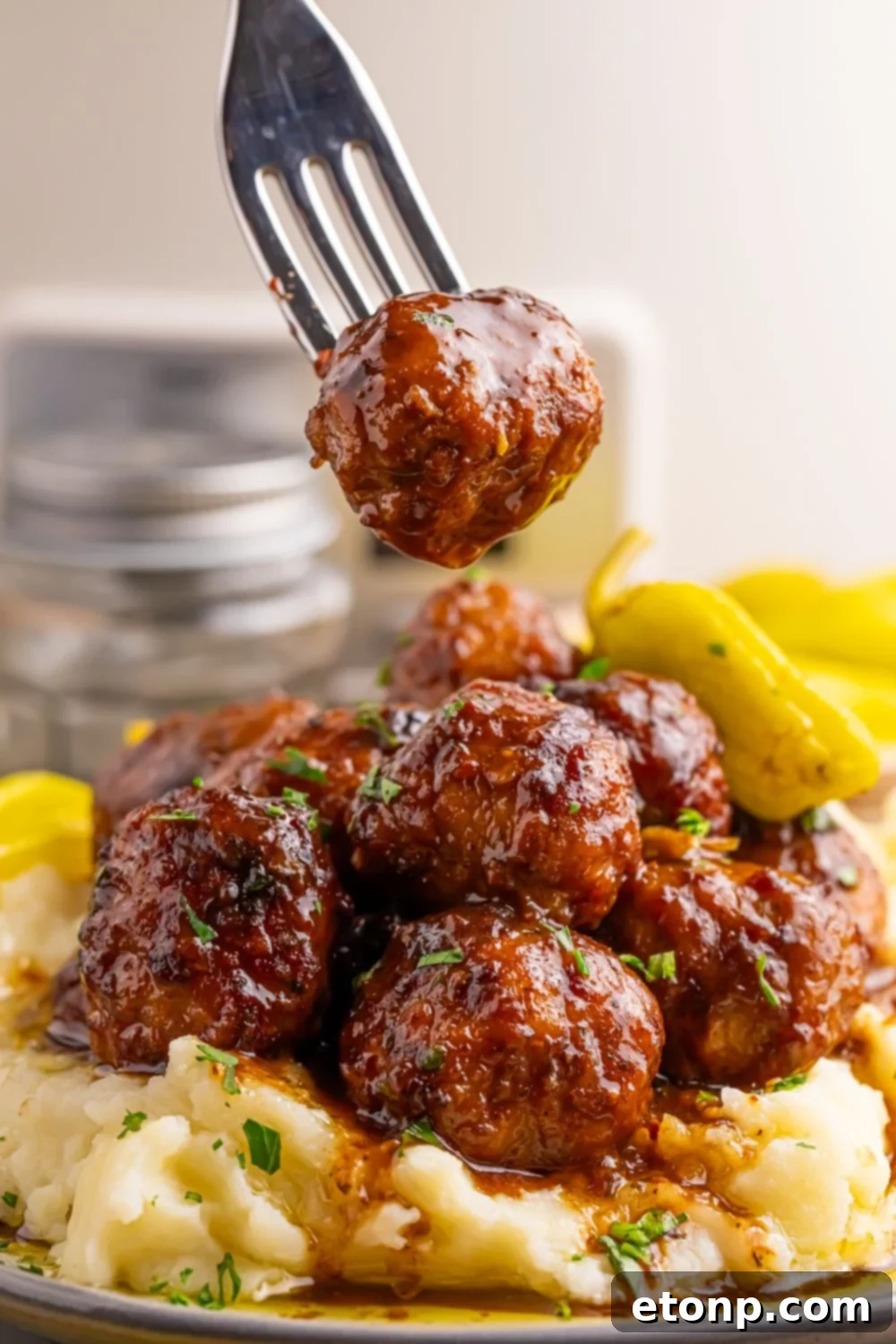 5 Ingredient Crockpot Mississippi Meatballs 13 Crockpot Mississippi Meatballs on a plate with a fork lifting one off the plate