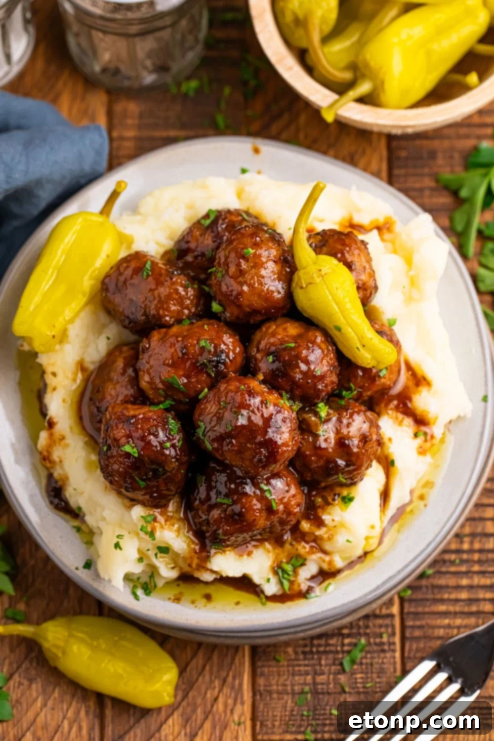 5 Ingredient Crockpot Mississippi Meatballs 19 Crockpot Mississippi Meatballs on a plate with a bed of mashed potatoes and a couple of peppers