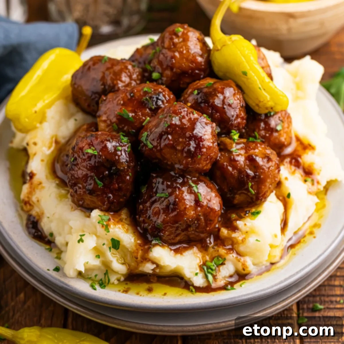 5 Ingredient Crockpot Mississippi Meatballs 3 Crockpot Mississippi Meatballs on a plate with a bed of mashed potatoes underneath