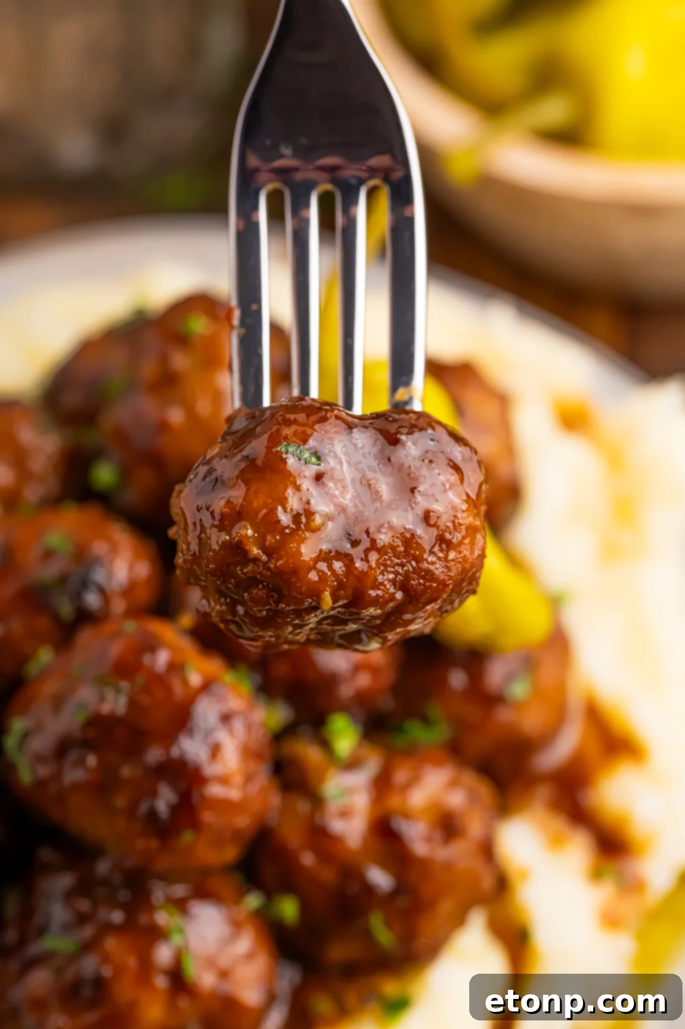 5 Ingredient Crockpot Mississippi Meatballs 21 mashed potatoes and Crockpot Mississippi Meatballs on a plate and a fork with one meatball poked into it