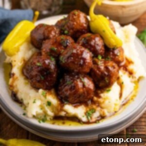 5 Ingredient Crockpot Mississippi Meatballs 25 Crockpot Mississippi Meatballs on a plate with a bed of mashed potatoes underneath