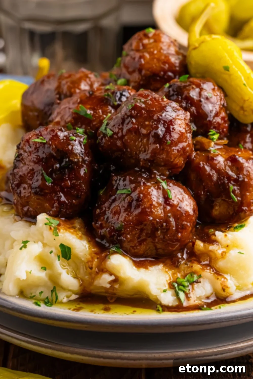 5 Ingredient Crockpot Mississippi Meatballs 6 Crockpot Mississippi Meatballs piled on a plate with mashed potatoes