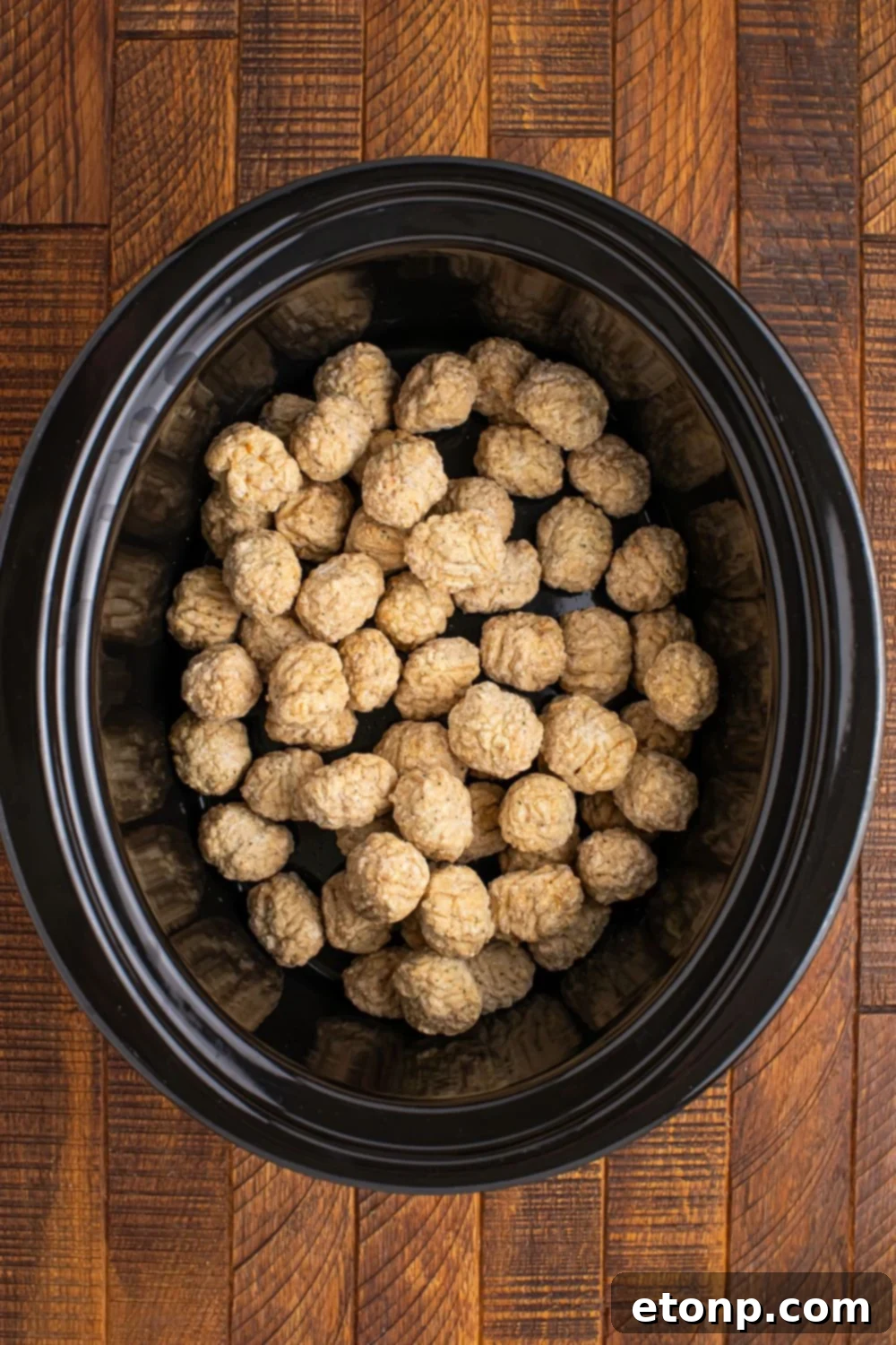 5 Ingredient Crockpot Mississippi Meatballs 10 frozen meatballs in a CrockPot on table