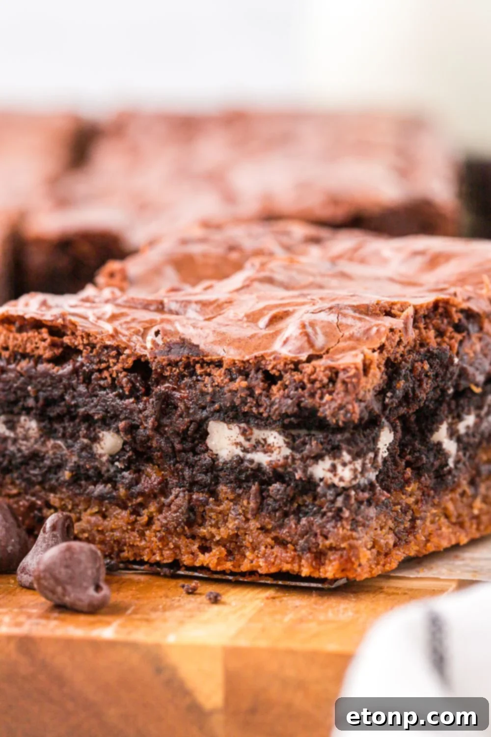Slutty Brownies sliced and place on tray with a close up of the layers of brownies 