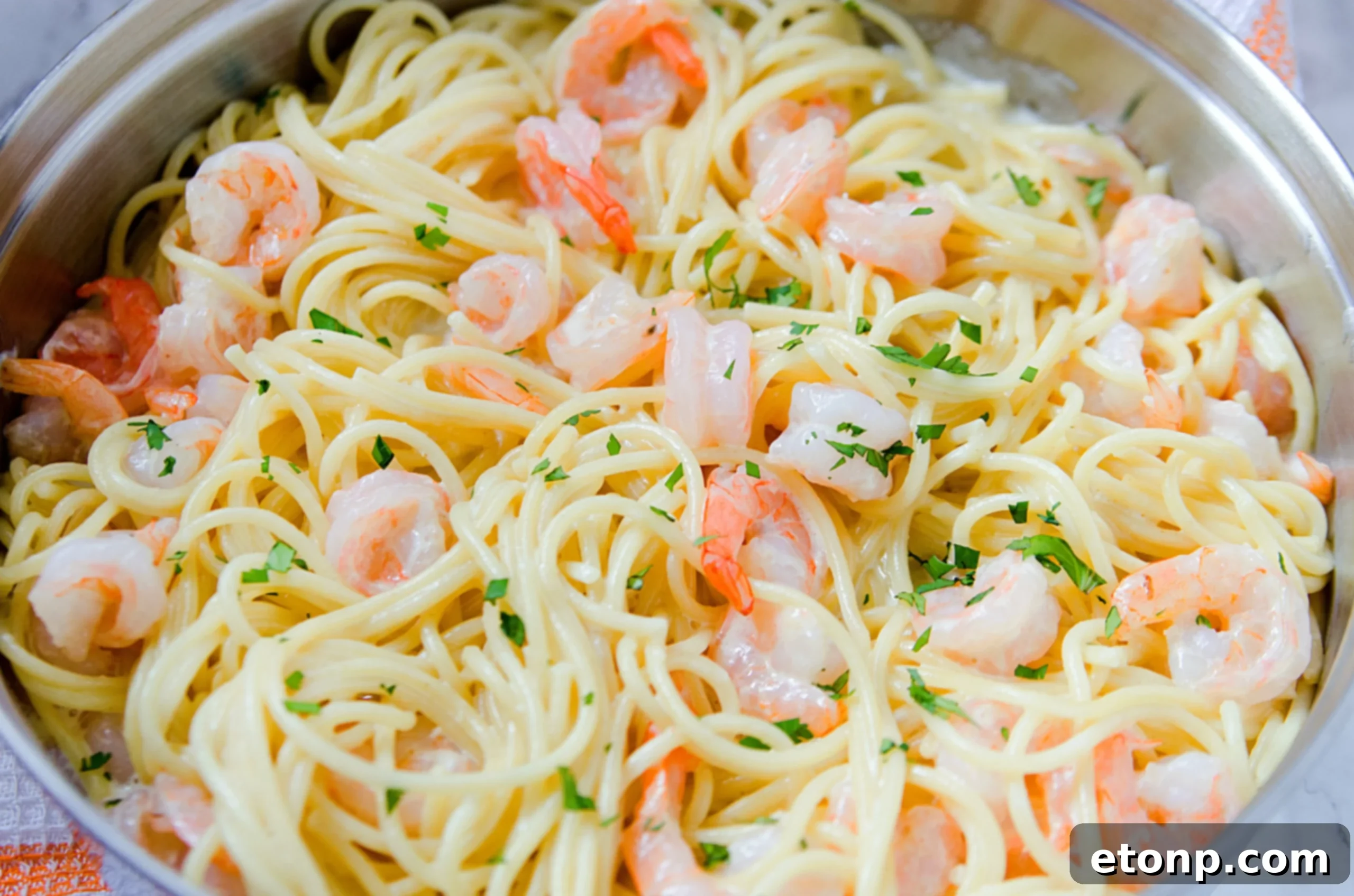 The fully assembled Four Cheese Garlic Shrimp Pasta in a large serving bowl, ready to be dished out, with a focus on the rich sauce.