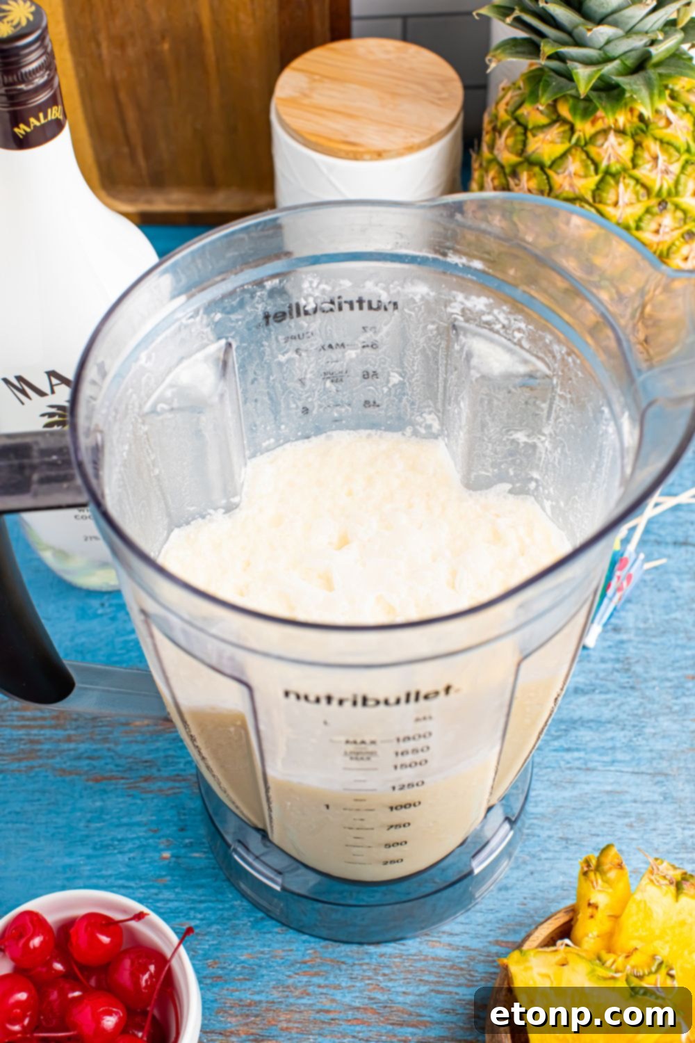 blender with Frozen Malibu Piña Colada mix in the container