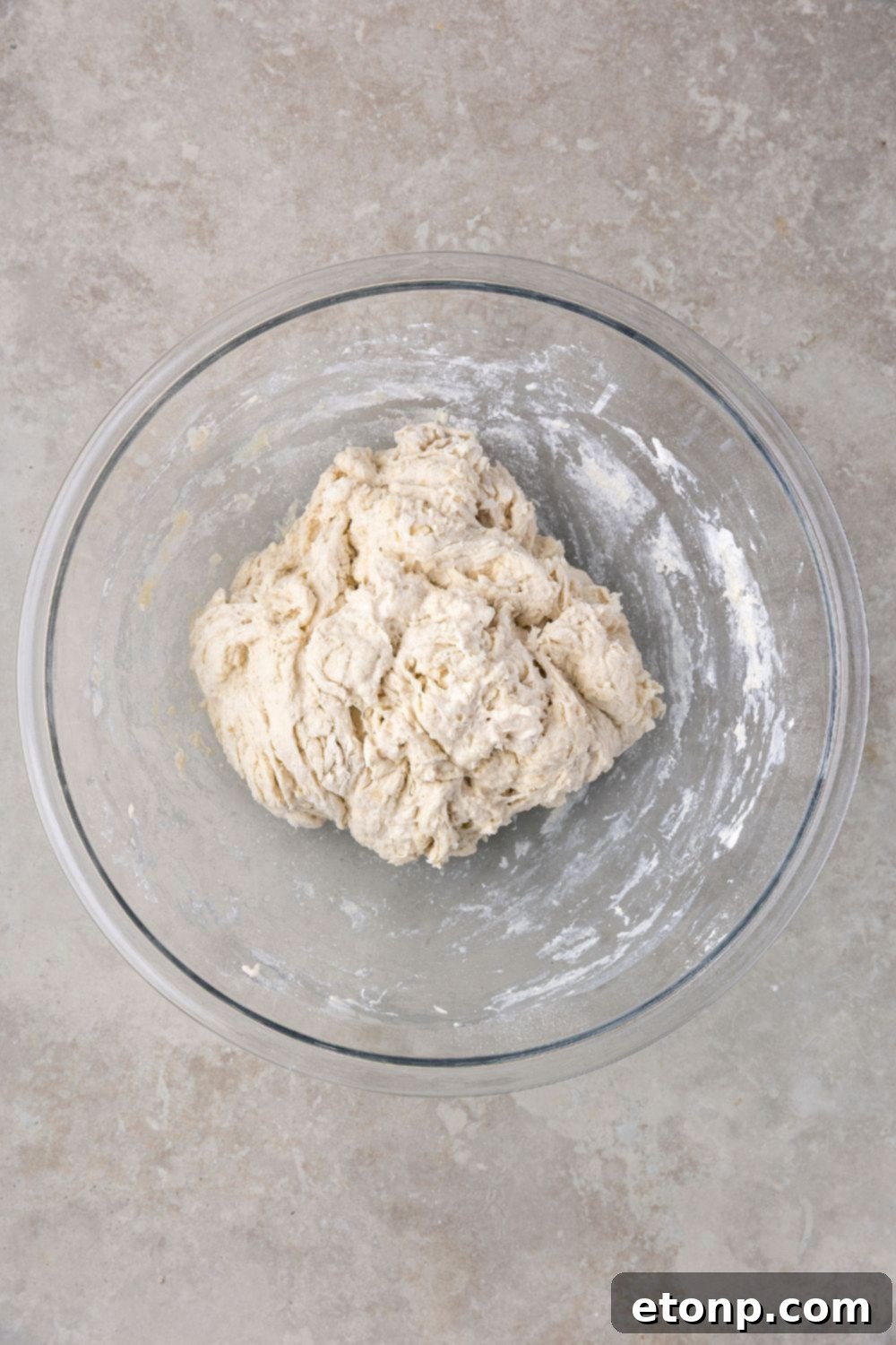 rough mixed dough for Homemade Sourdough Bread on table 
