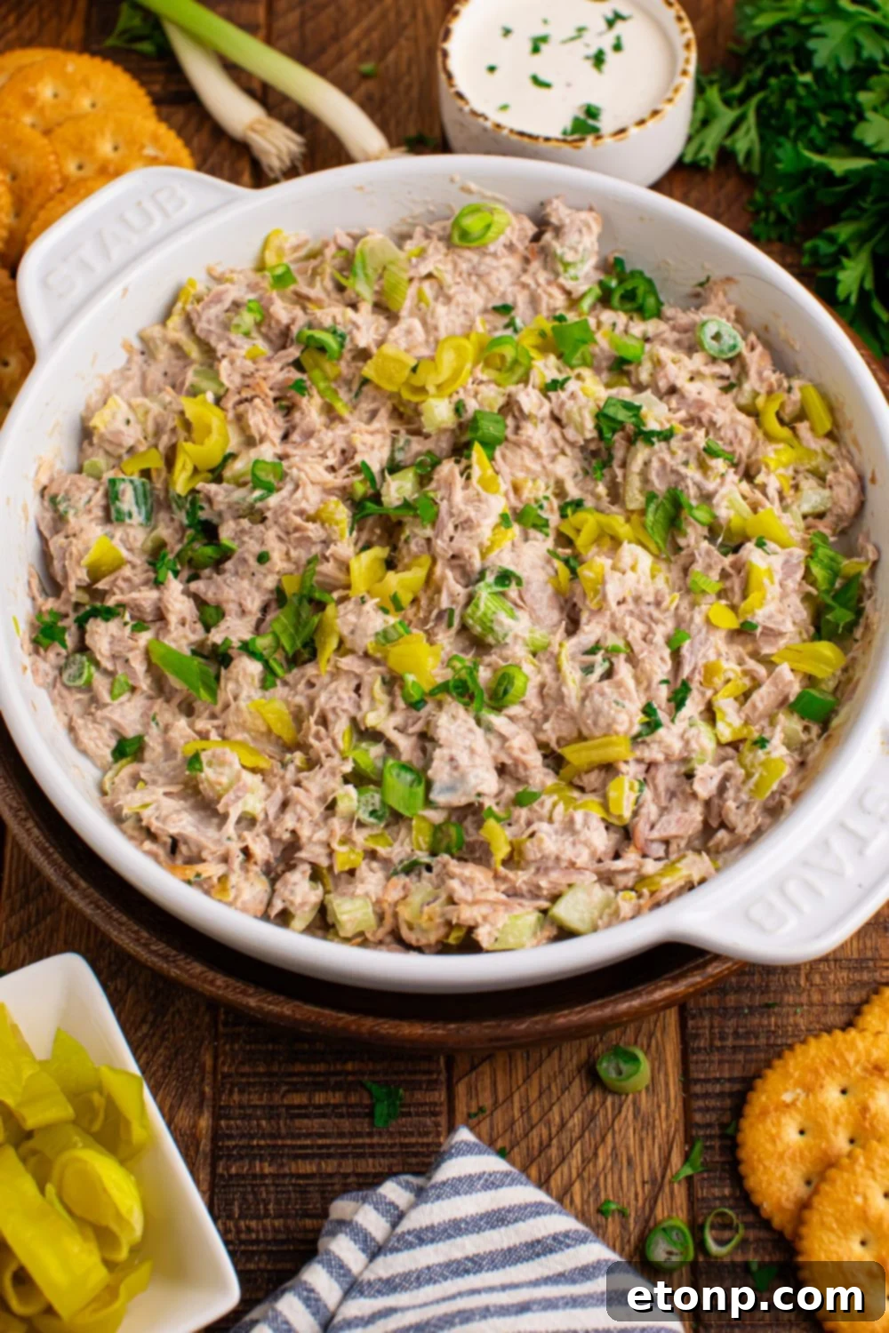Pepperoncini Ranch Tuna Salad in a white bowl on a table, with crackers on the side for dipping