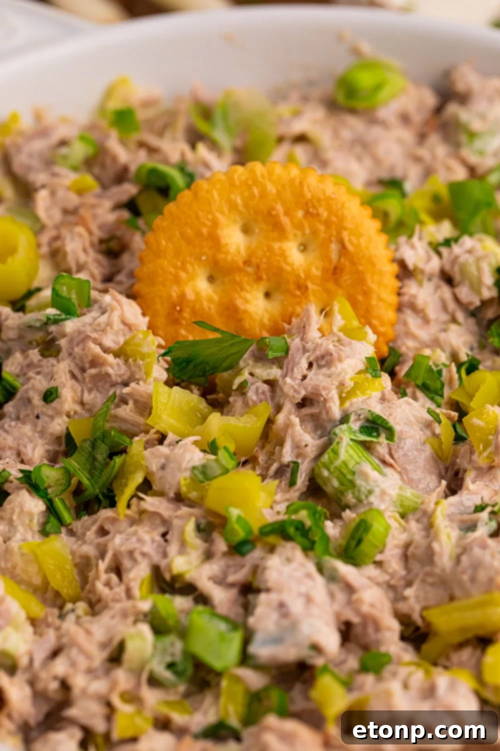 Bowl of Pepperoncini Ranch Tuna Salad with a cracker pressed into it, ready to eat