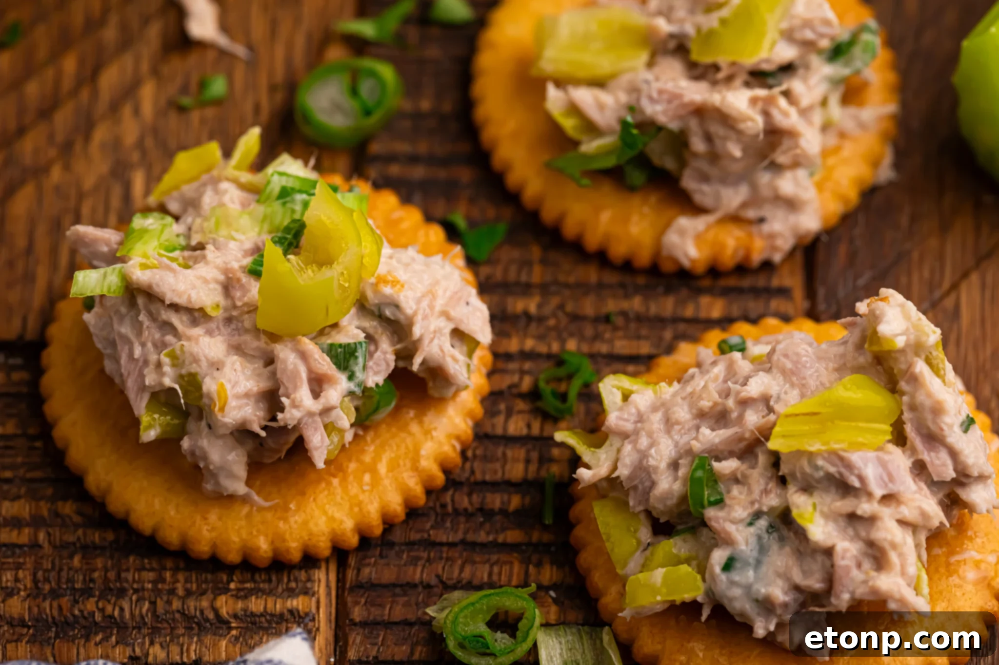 Pepperoncini Ranch Tuna Salad on a few crackers, garnished with fresh herbs