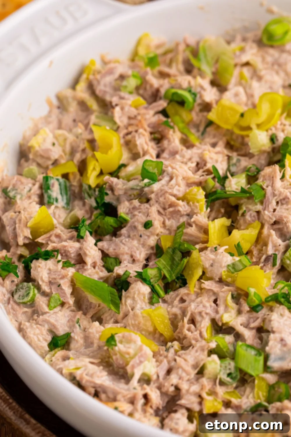 Pepperoncini Ranch Tuna Salad in a white bowl on a light-colored table, ready to be served