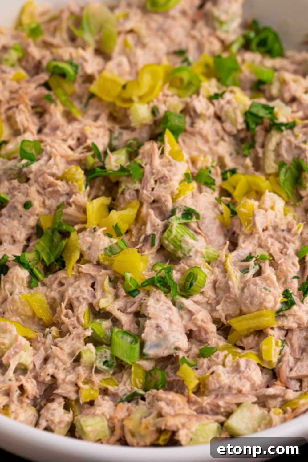 Close up of Pepperoncini Ranch Tuna Salad in a bowl, showing texture and ingredients