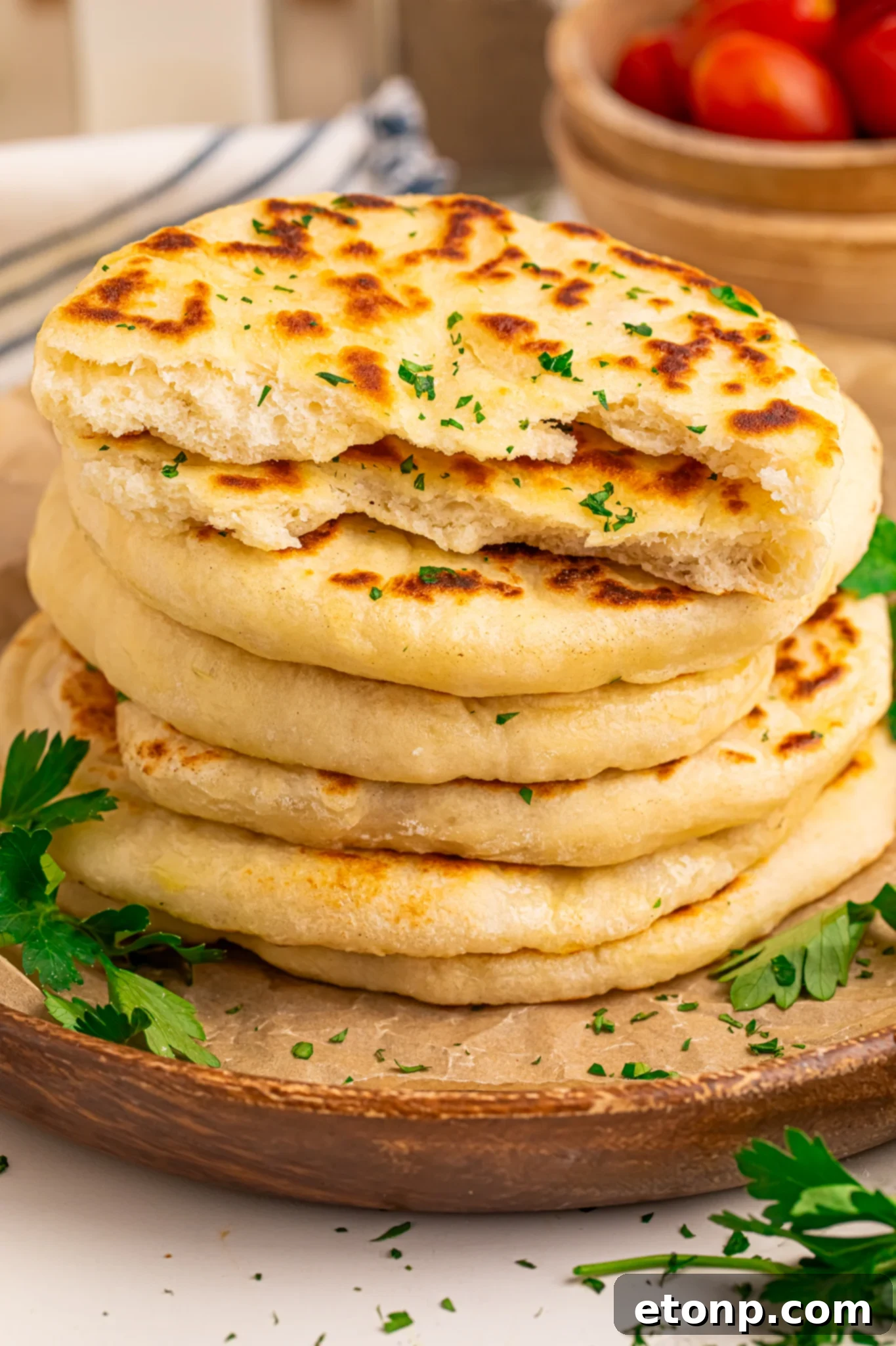 3 Ingredient Flatbread stacked on table with one split in half showing texture 