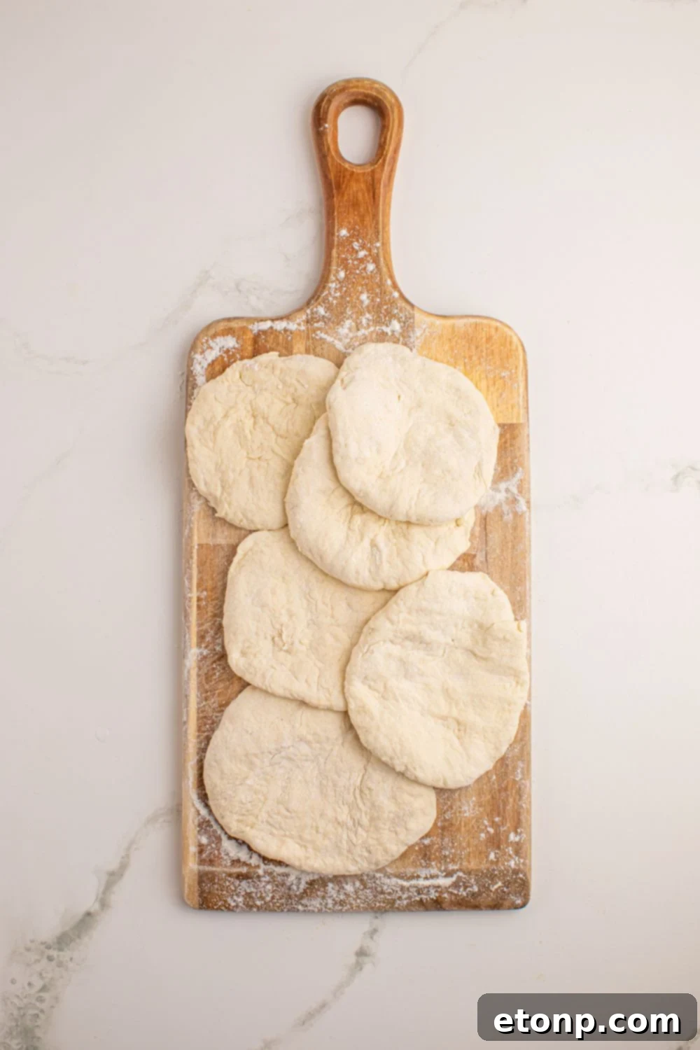 3 Ingredient Flatbread dough rolled out into circles on a cutting board 