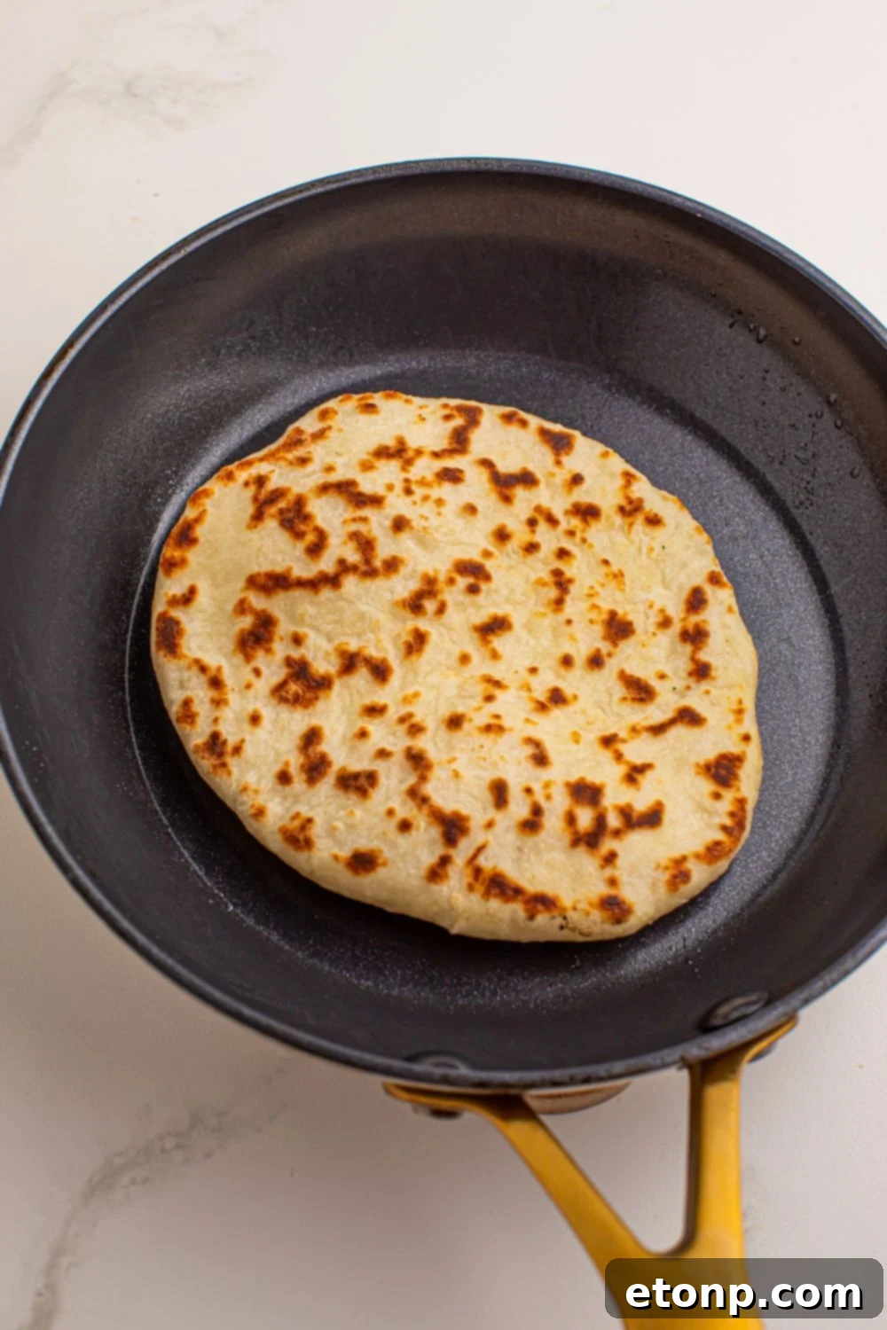 skillet with a 3 Ingredient Flatbread in it browning up 