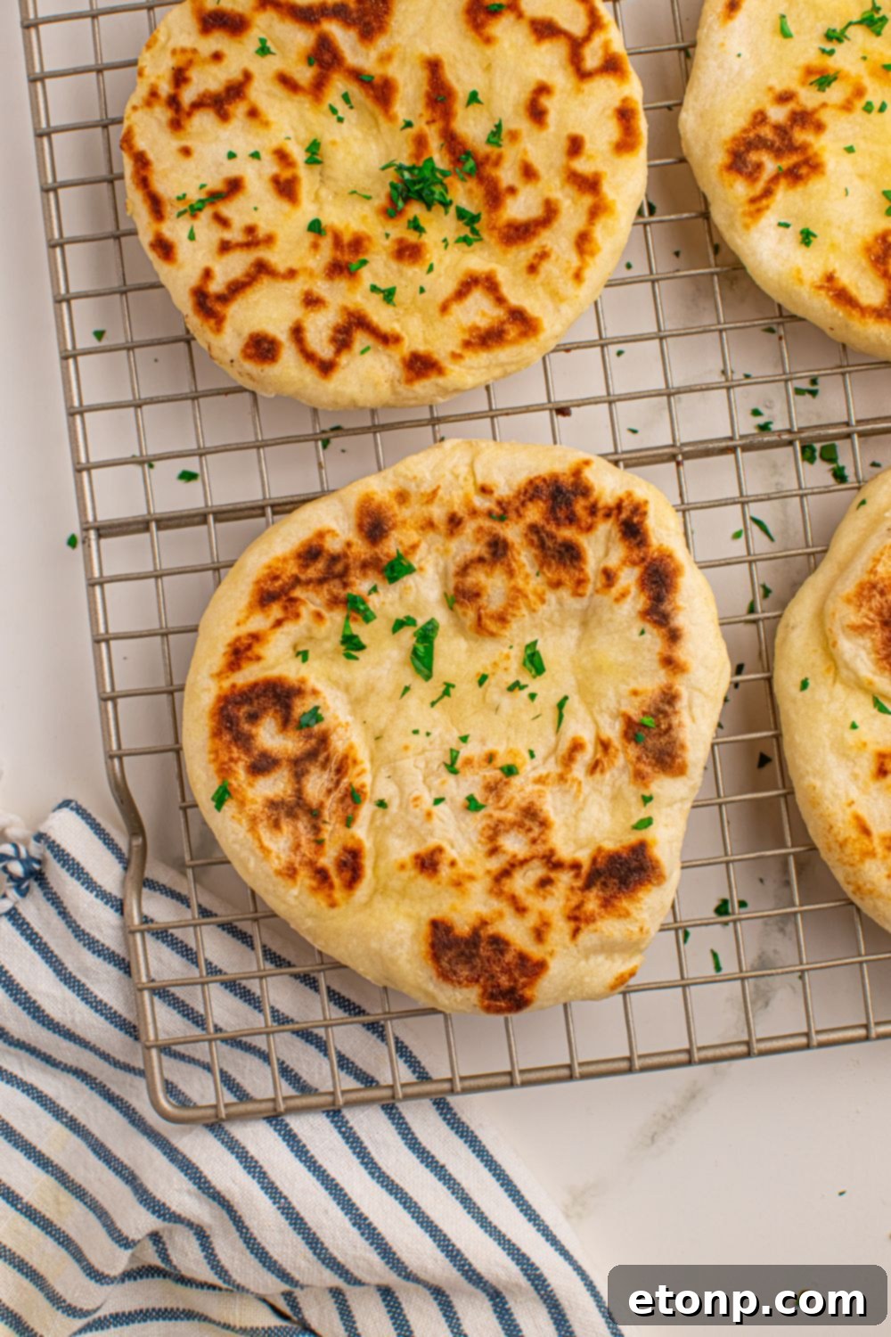 3 Ingredient Flatbreads on cooling rack with a towel under cooling rack 