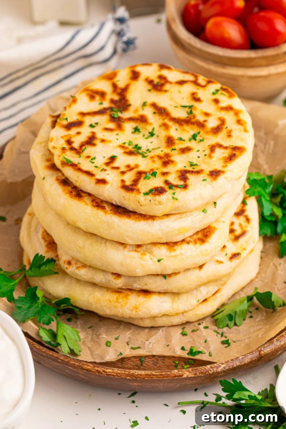 stack of 3 Ingredient Flatbread on tray with bowls of tomatoes to side 