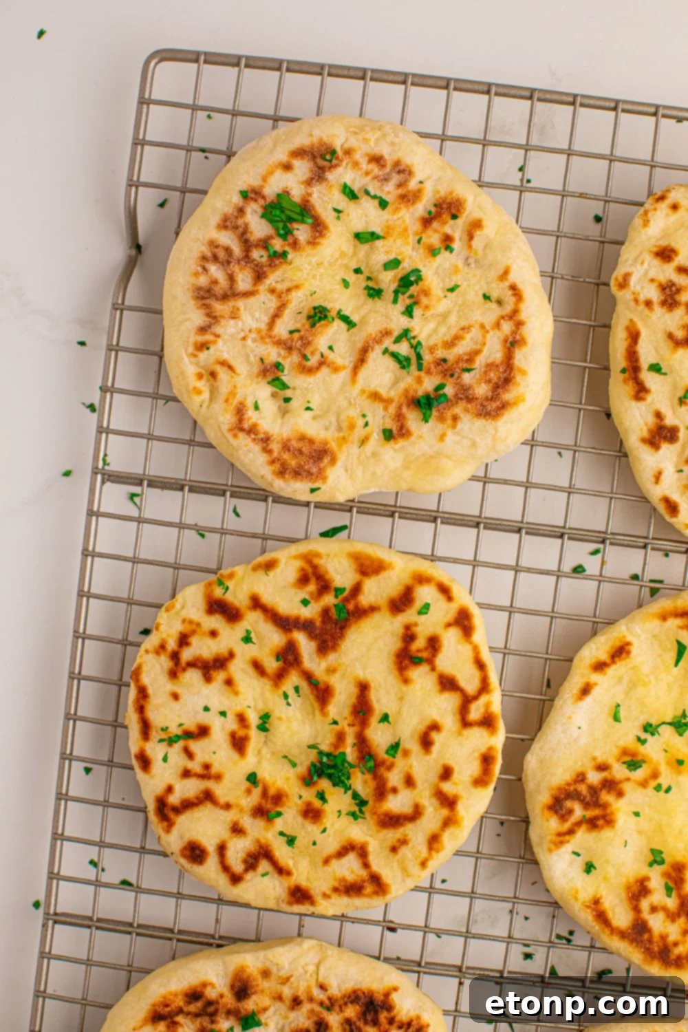 3 Ingredient Flatbread spread out on cooling rack on table 