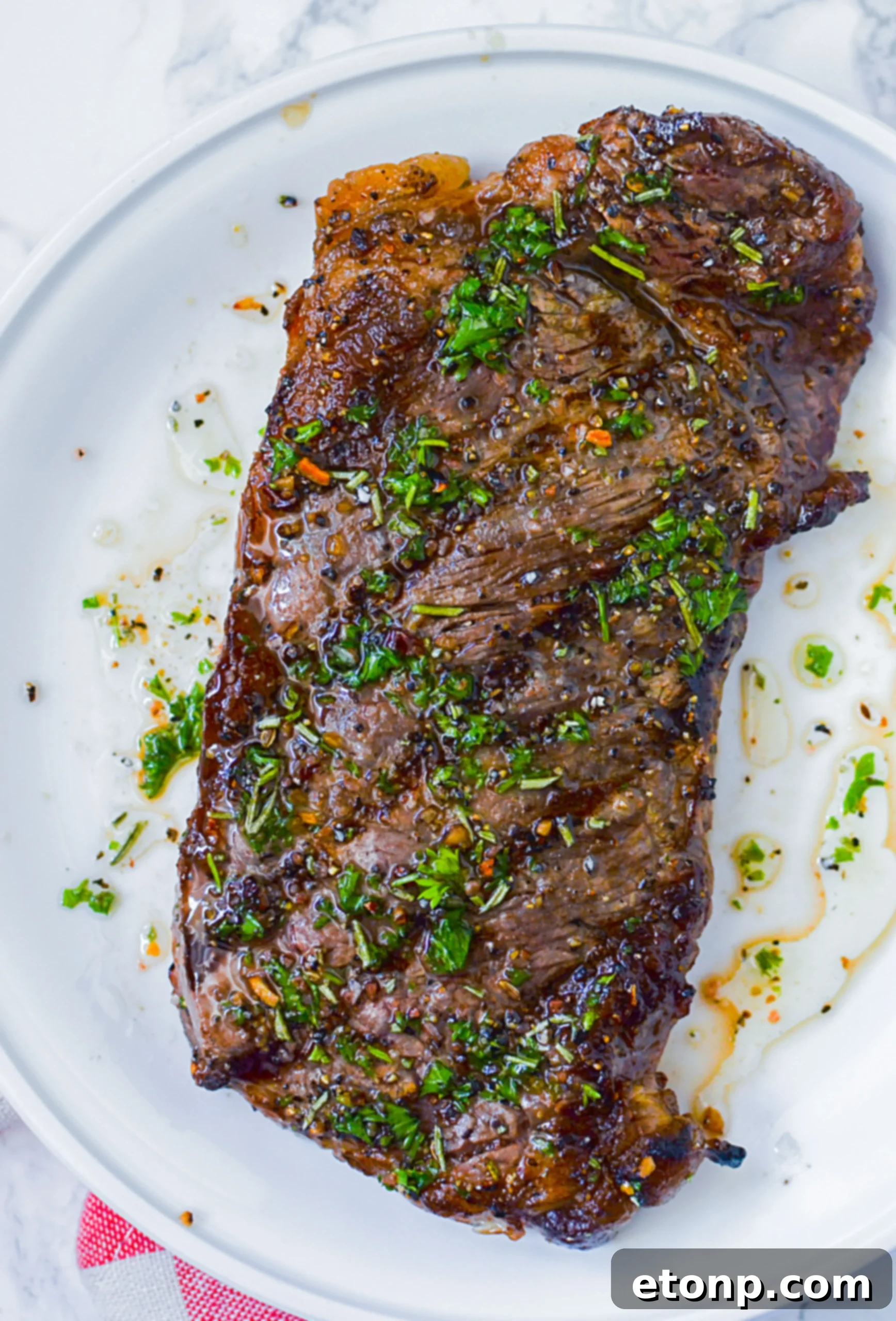 Perfectly grilled steak, glistening with marinade and juices, ready to be served.