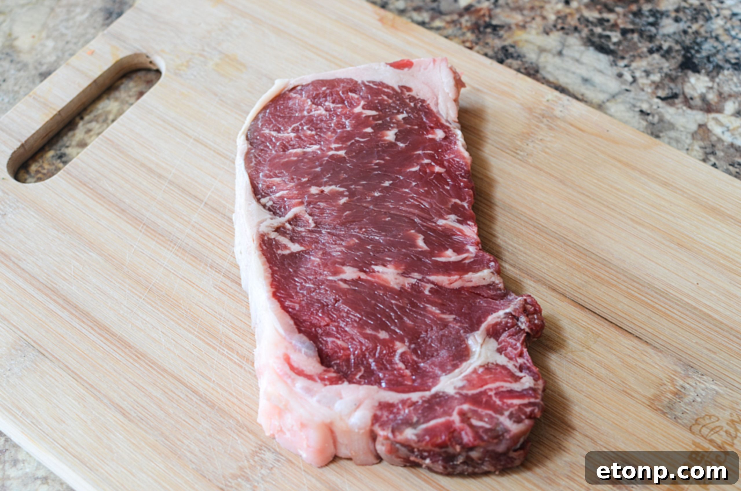 Close-up of a beautifully seared steak on a cutting board, showcasing its juicy interior.