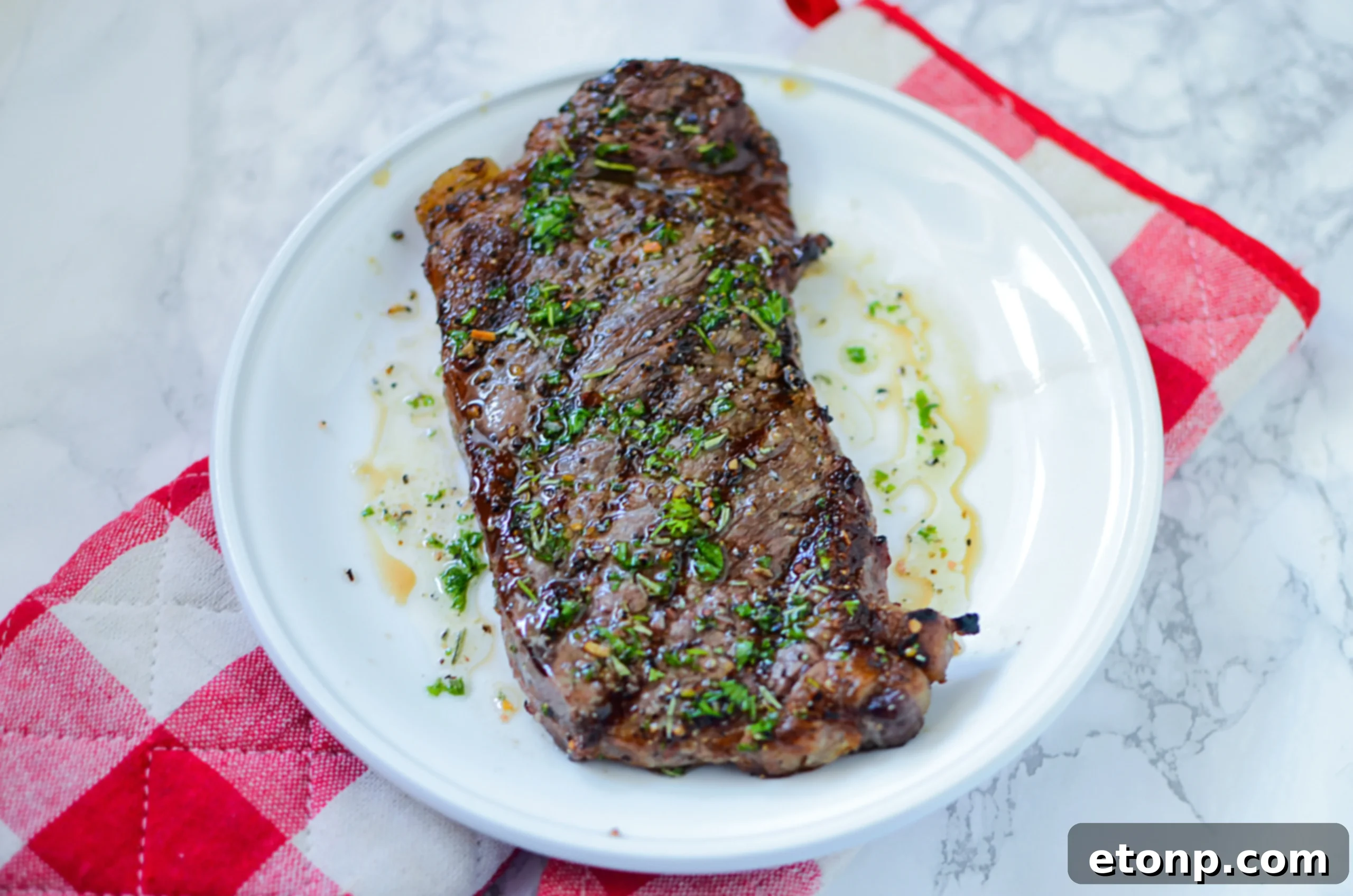 Grilling steaks on a hot BBQ, being basted with a rich, dark glaze to enhance flavor and crust.
