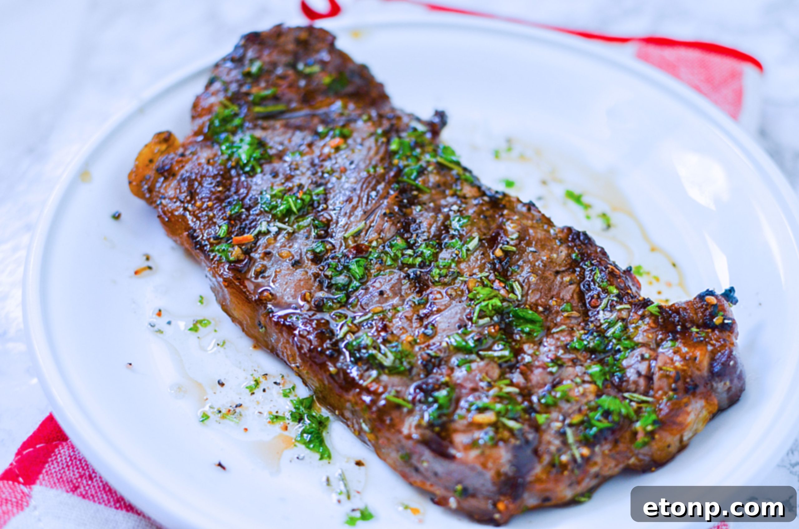 A plate of perfectly grilled steaks, garnished with fresh herbs, ready to be enjoyed.