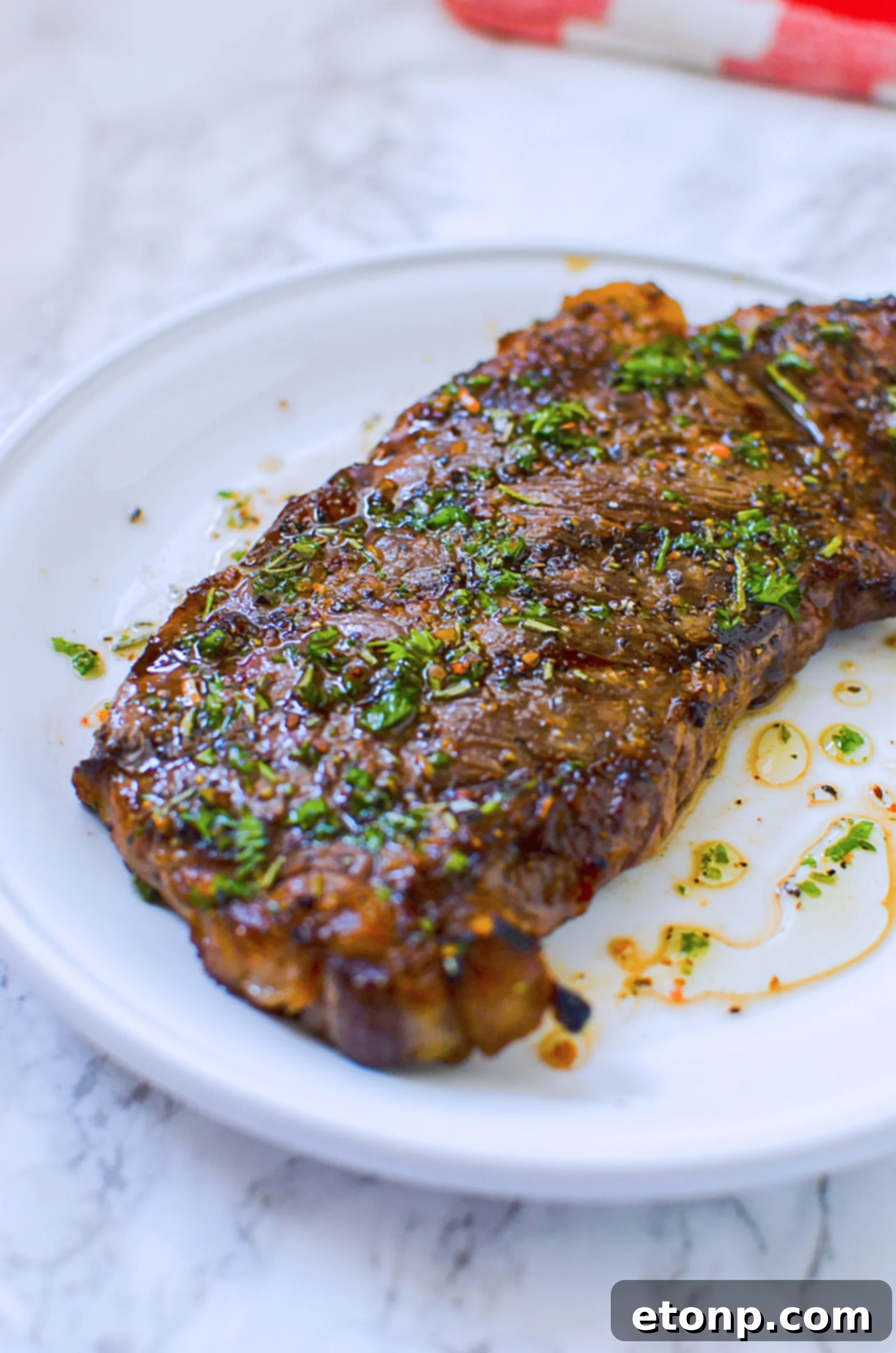 Another perspective of a grilled steak, showcasing its beautiful char marks and appealing, juicy texture.