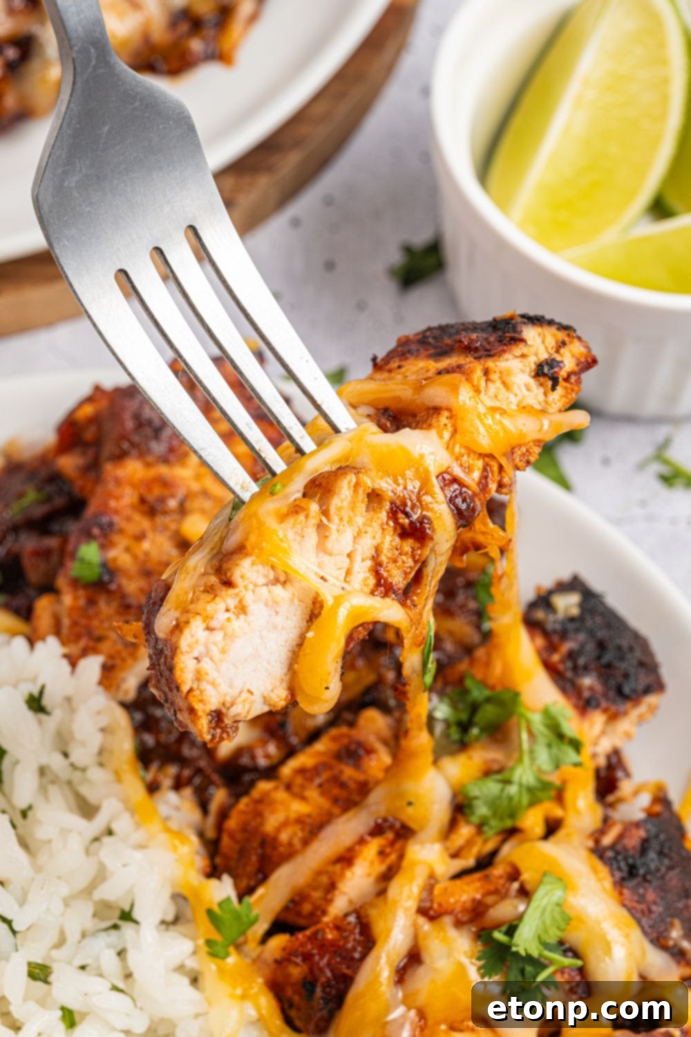 One Pan Cheesy Salsa Chicken 14 Cheesy Salsa Chicken on fork with cheese