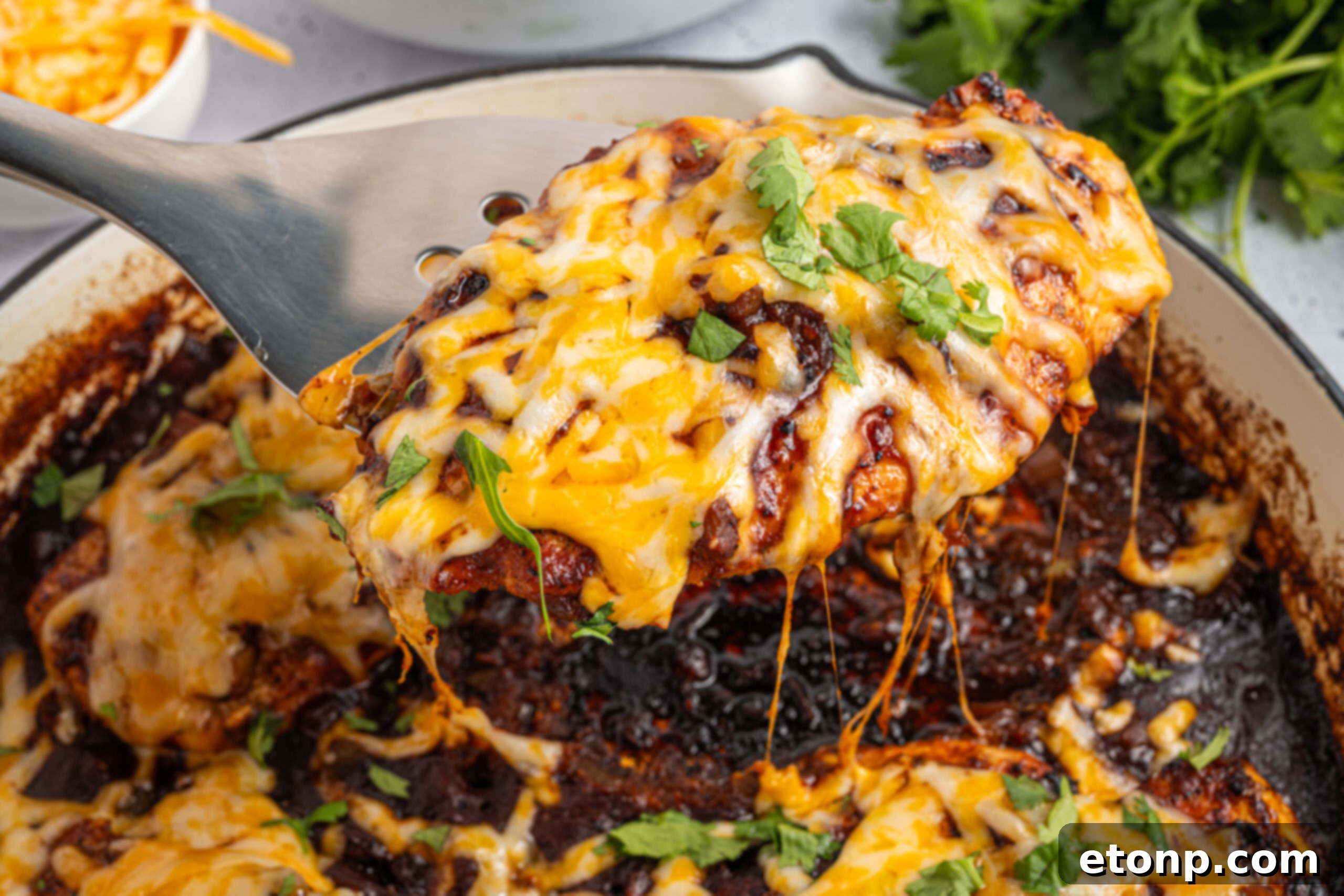One Pan Cheesy Salsa Chicken 19 Cheesy Salsa Chicken on pan with a spatula being lifted out of pan