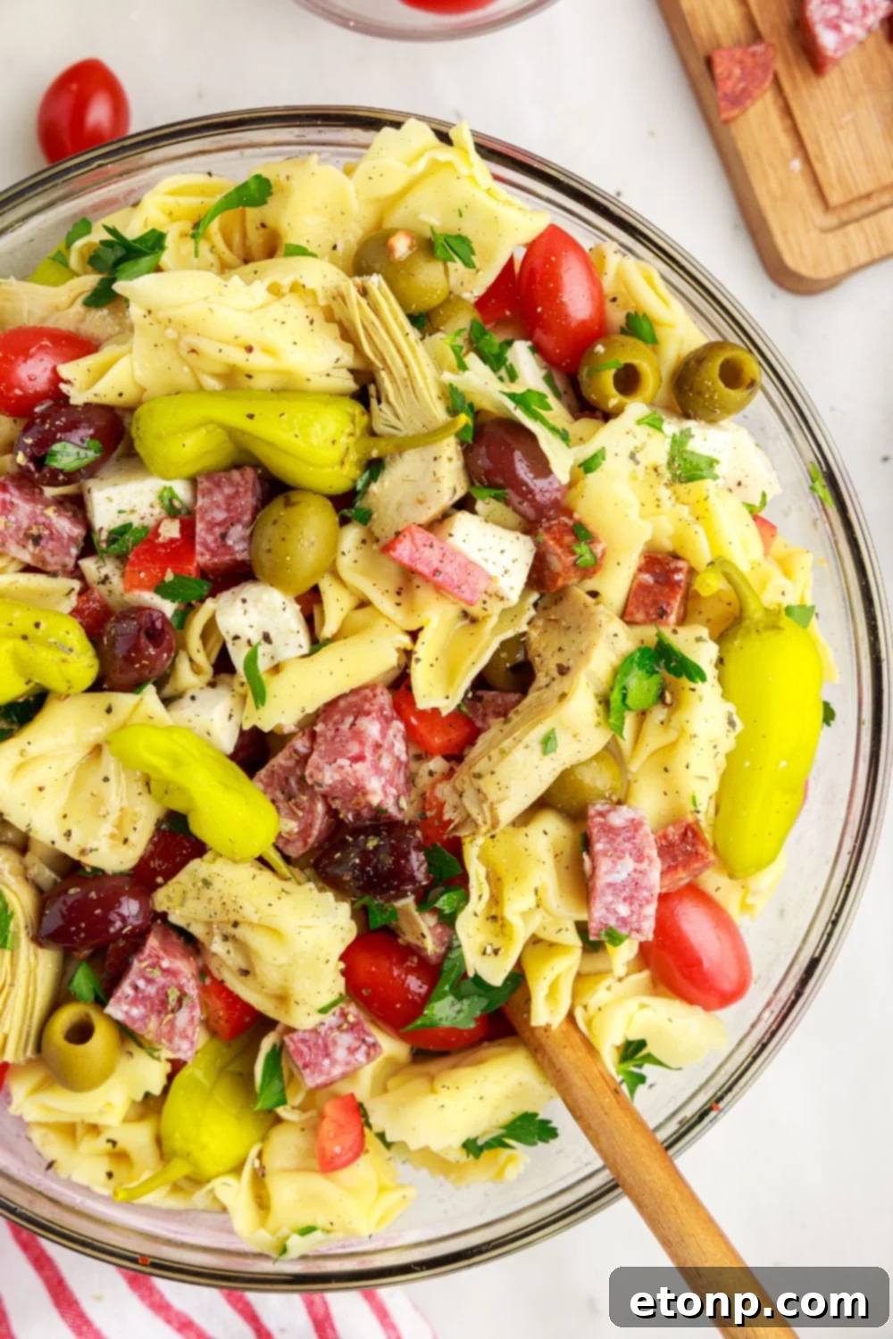 Overhead view of Antipasto Tortellini Pasta Salad in a bowl, showcasing the generous amount of meats, cheeses, and vegetables.