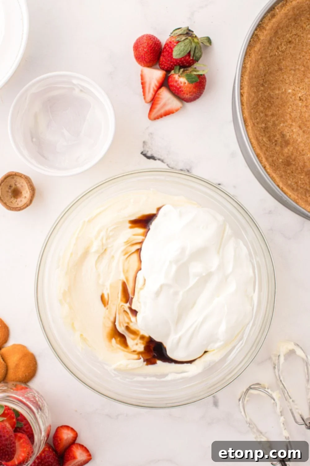 All the creamy ingredients for the No Bake Strawberry Cheesecake filling blended smoothly in a large bowl, ready for the crust.