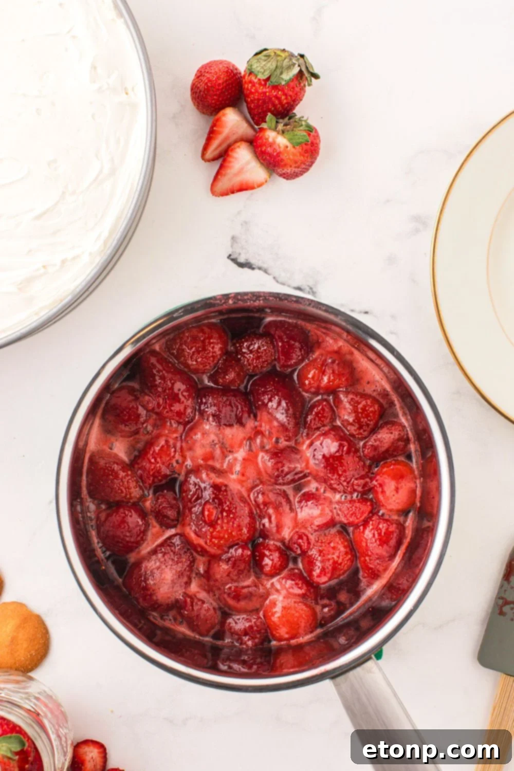 Fresh strawberries cooked down into a rich, glossy glaze, ready to generously top the No Bake Strawberry Cheesecake.
