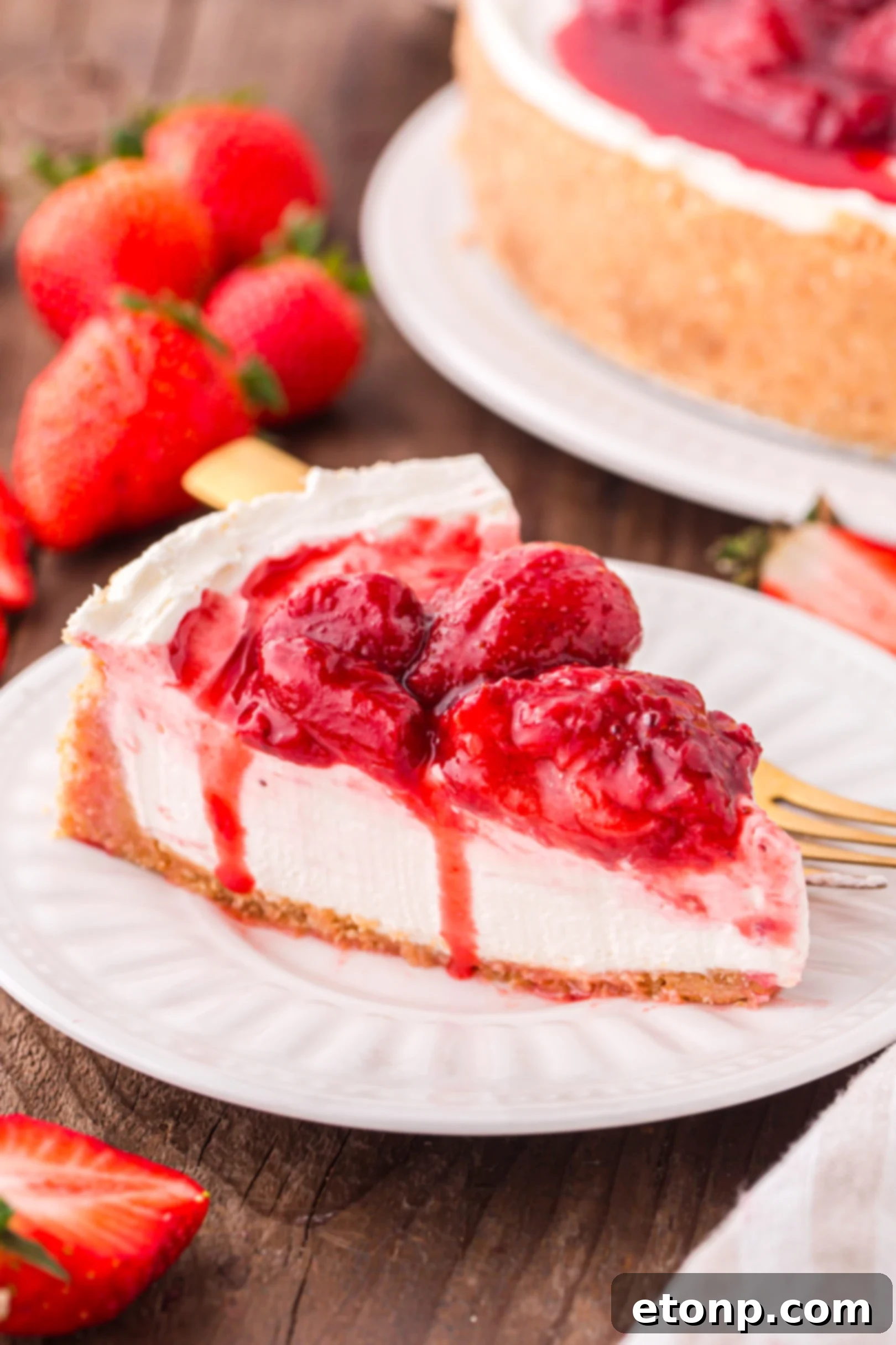 A generous slice of the No Bake Strawberry Cheesecake presented on a pristine white plate, showcasing its appealing layers and rich topping.