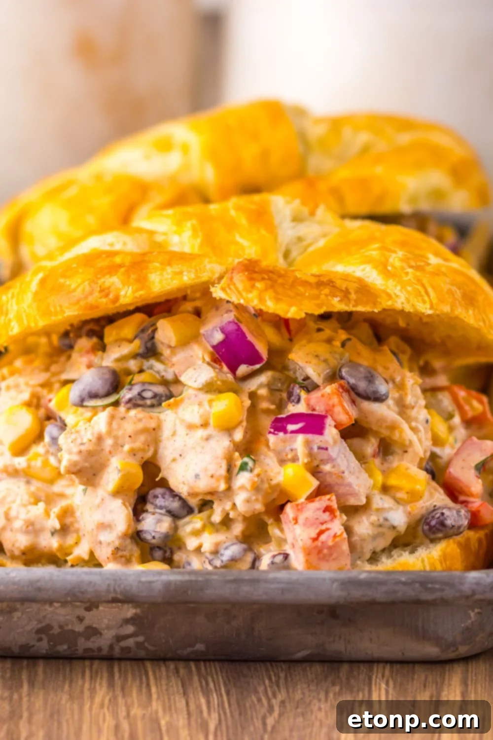 Close-up of Creamy Taco Chicken Salad sandwiches on a serving tray, garnished with cilantro.