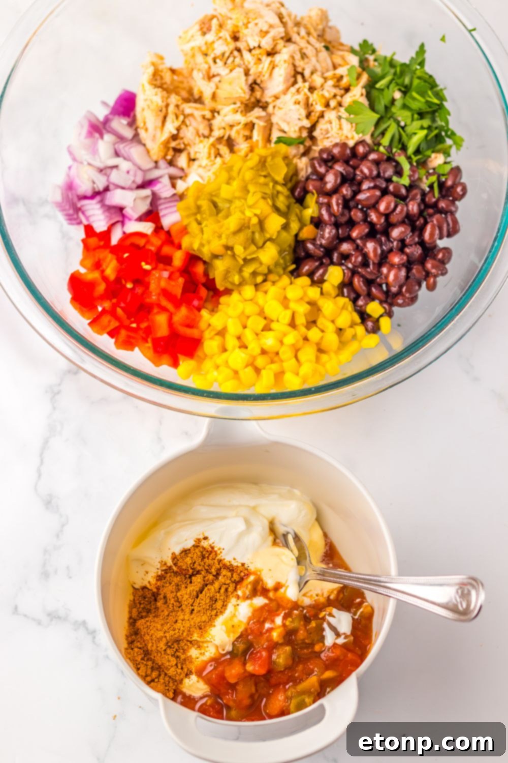 Creamy Taco Chicken Salad ingredients in separate bowls, with the creamy dressing in a smaller bowl.