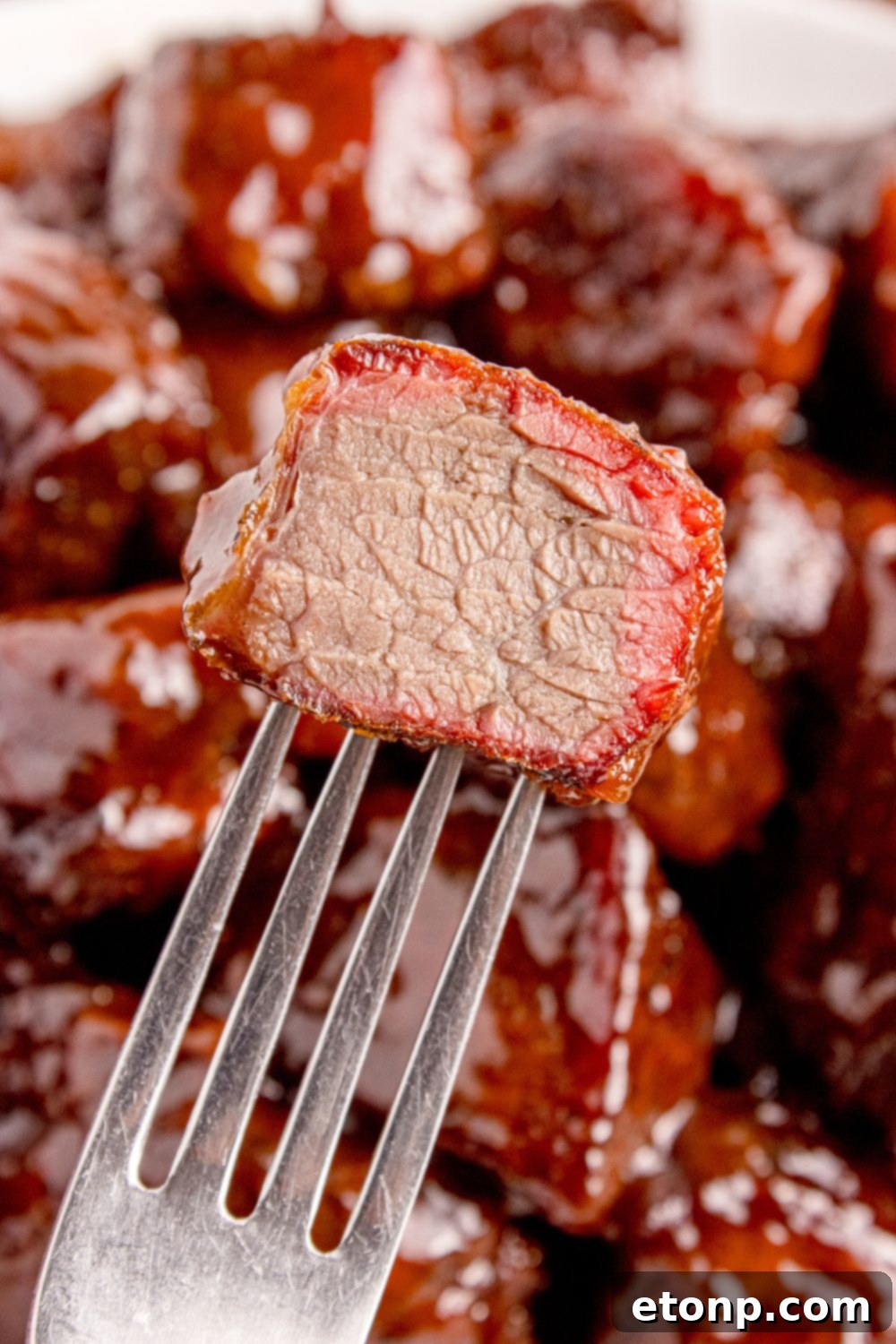 Chuck Roast Burnt End on a fork with a bite taken out of it