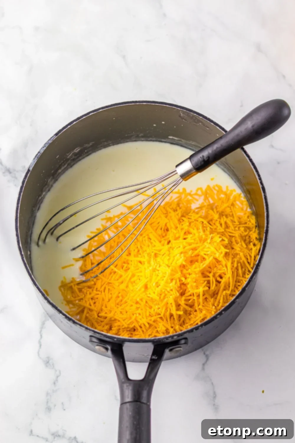 cheese and sauce in a saucepan sitting on table