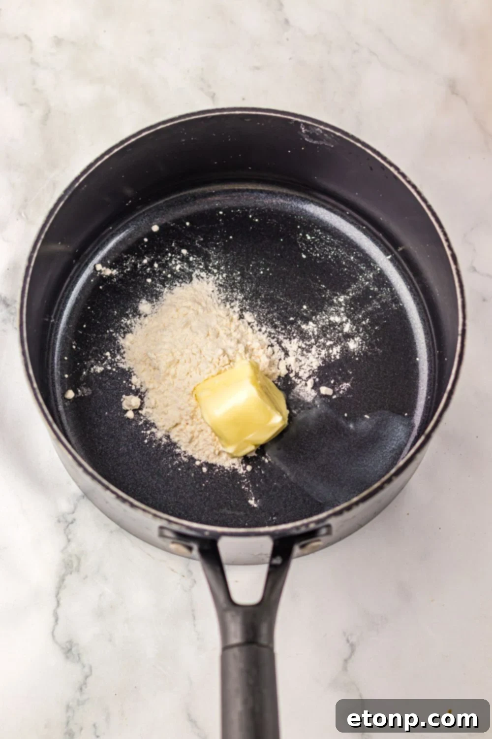 butter and flour in a saucepan on table