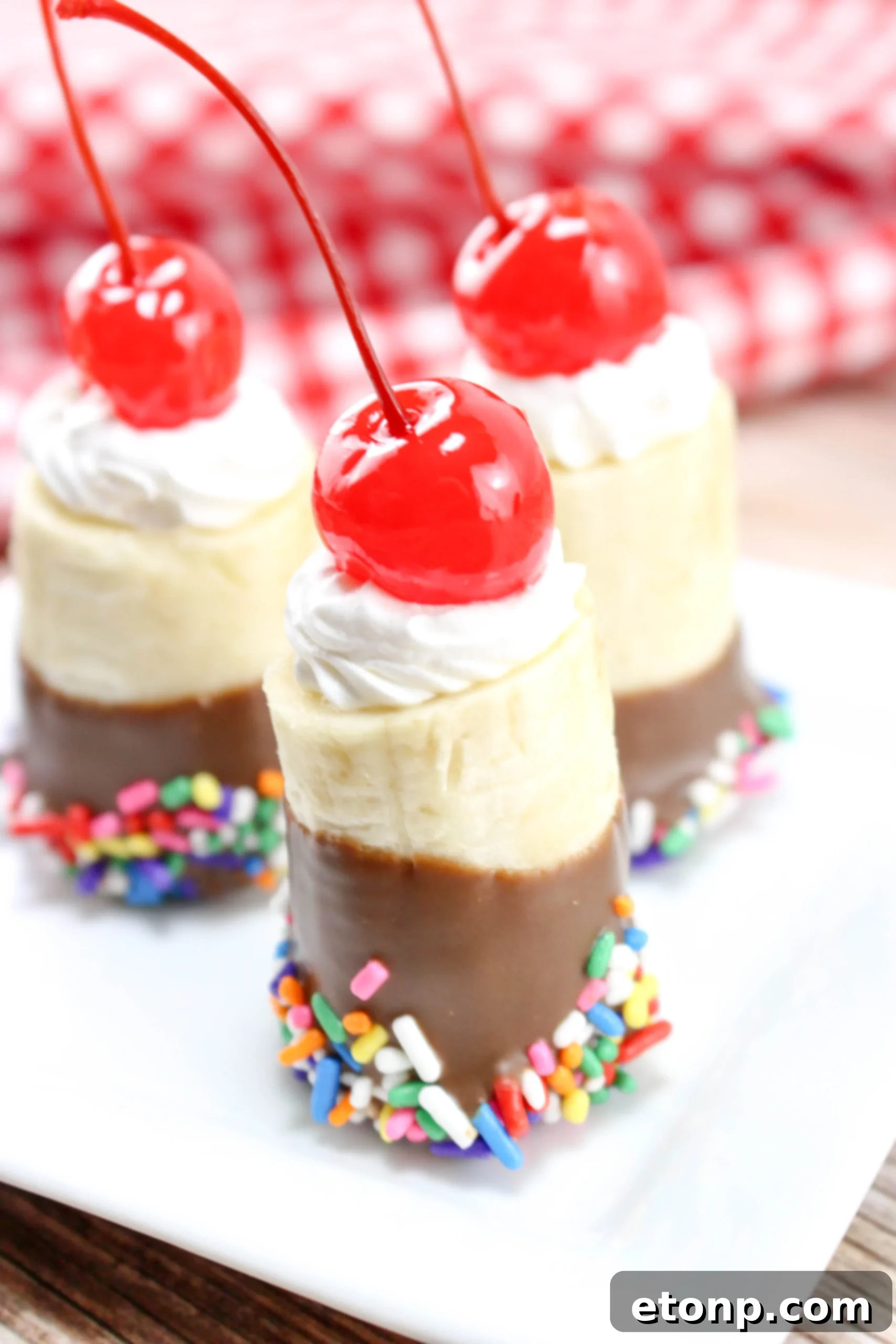 Close-up of a finished banana split bite on a white plate, showcasing its vibrant colors and delicious texture.