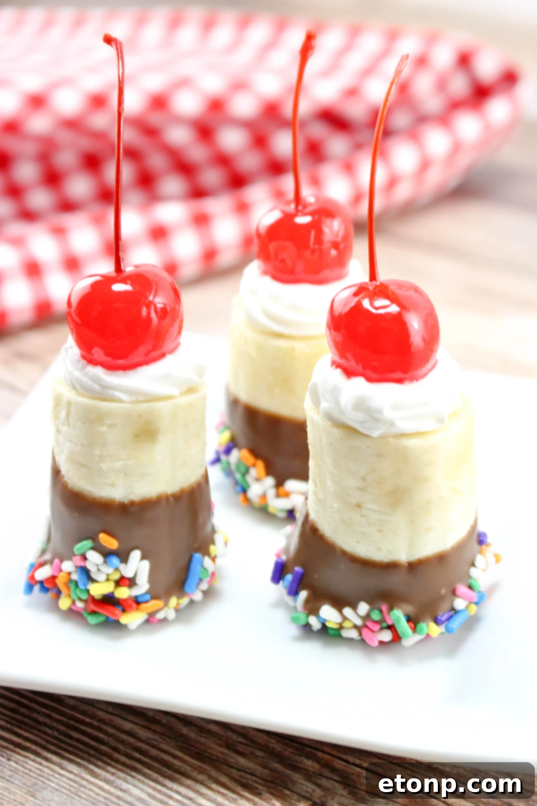 A serving of banana split bites presented beautifully, with a small scoop of vanilla ice cream, creating an elegant dessert plating.