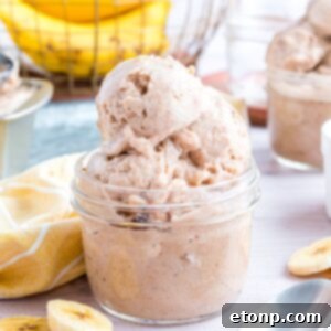 Banana Ice Cream in a glass bowl on table with slices of bananas around table