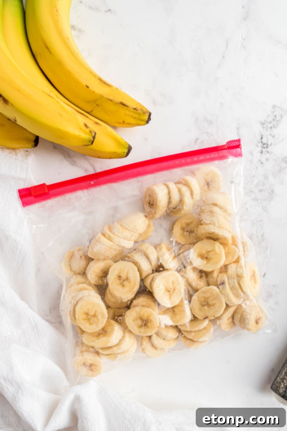 Effortless One-Ingredient Banana Ice Cream 7 frozen bananas in a ziploc bag on table
