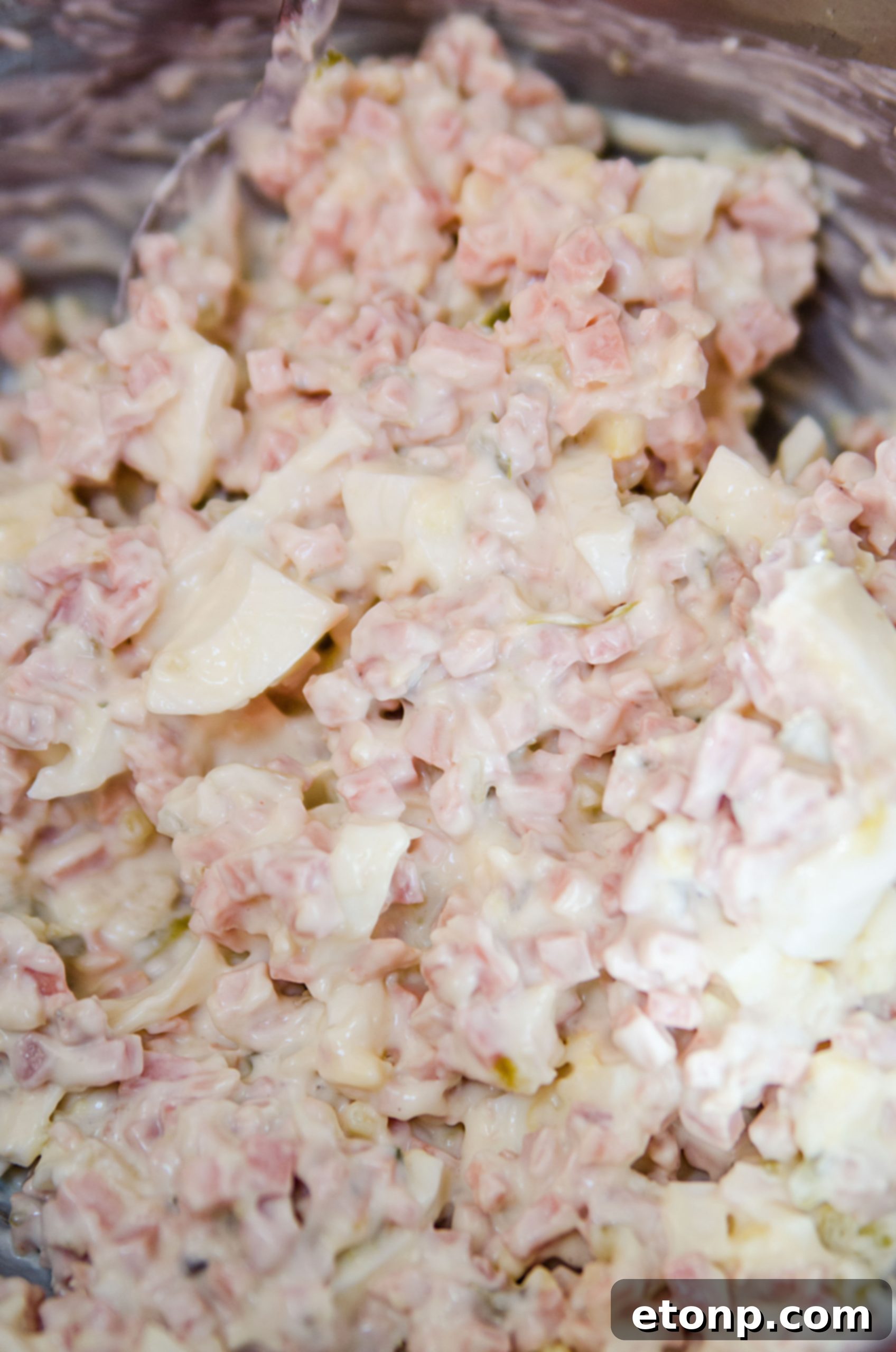 Chopped hard-boiled eggs and fried bologna ready for mixing in the salad