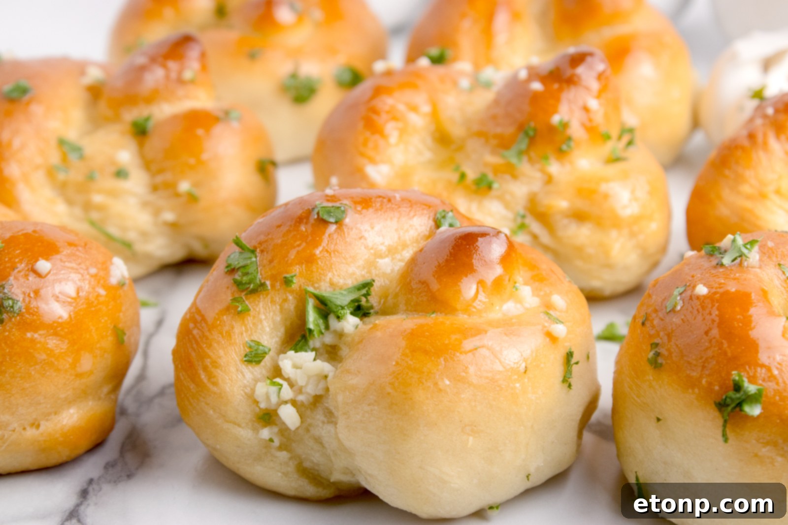 Homemade Garlic Knots on a white marble table 