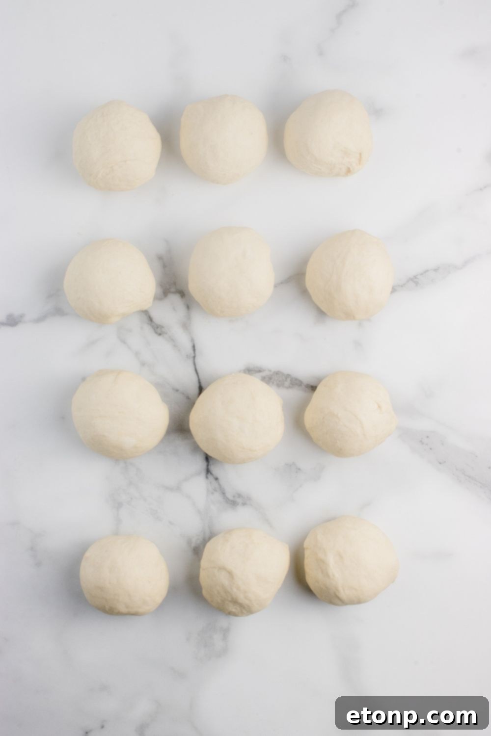 12 dough balls rolled in circles on table 