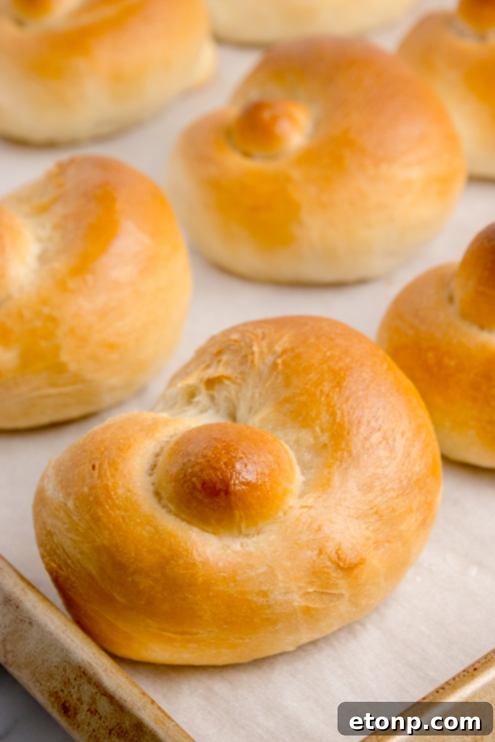 Homemade Garlic Knots on a baking sheet without the topping on them yet 
