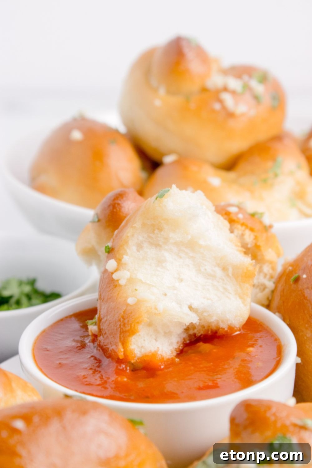 torn garlic knots in marinara sauce 